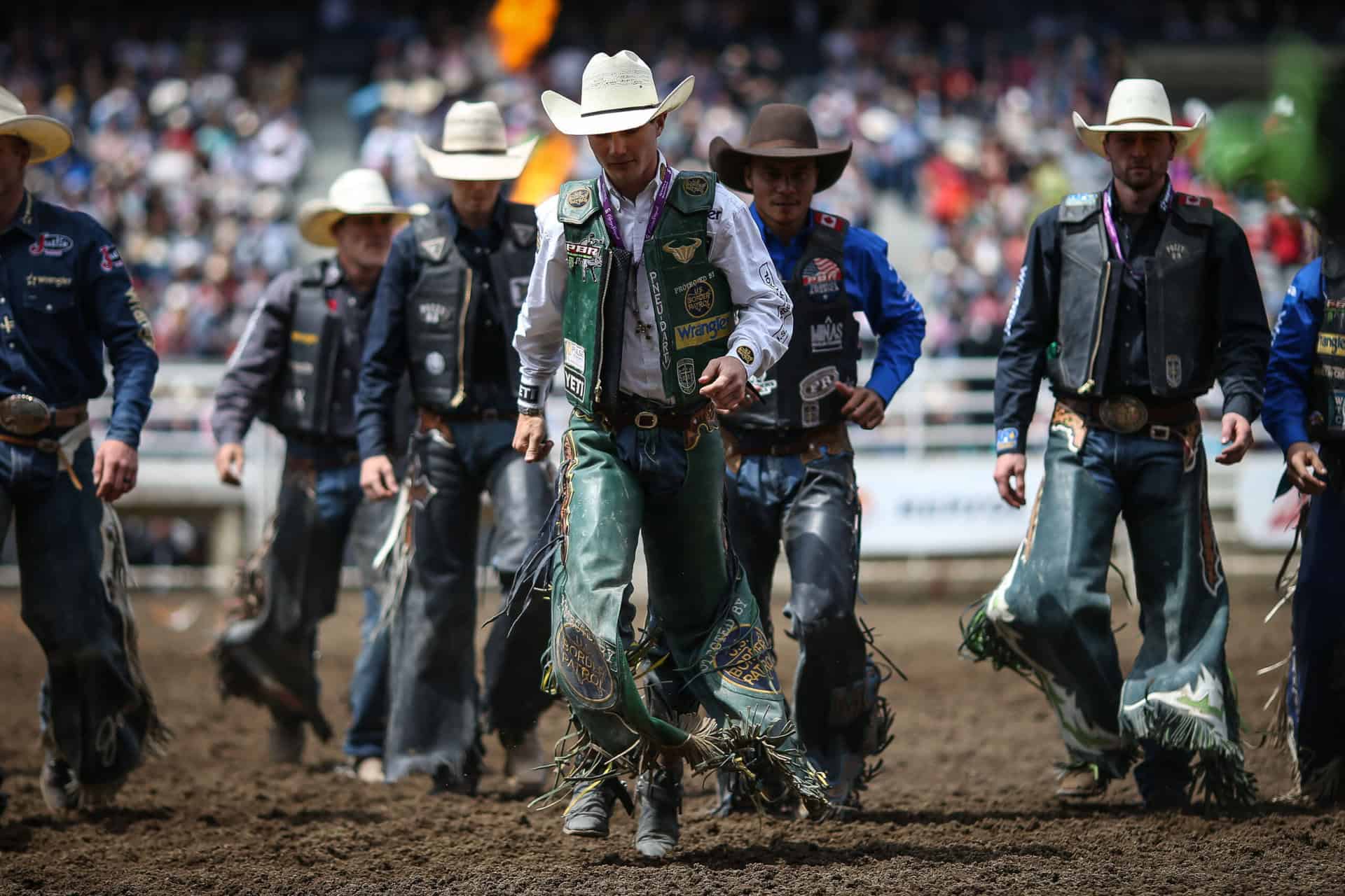 Group of men dressed in western wear walking in a group