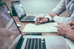 Two people working on compliance audit