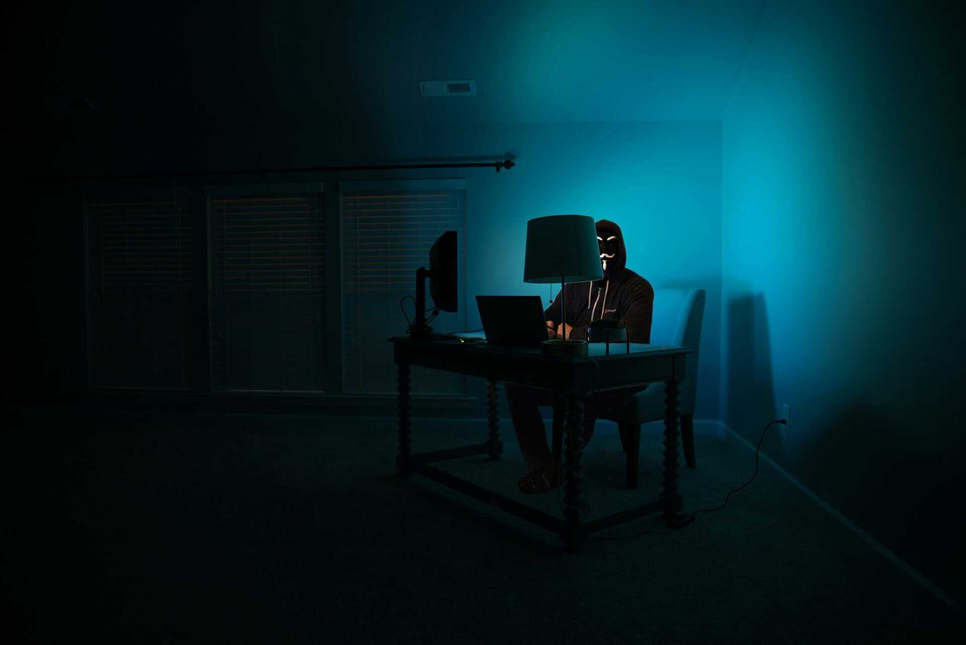 Man sitting facing a laptop