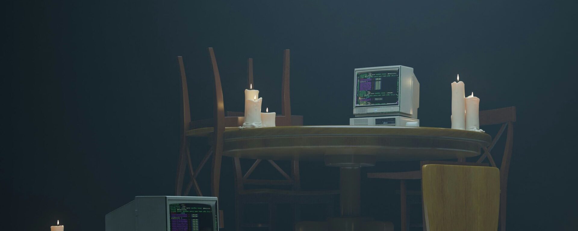 3 computers surrounded by candles
