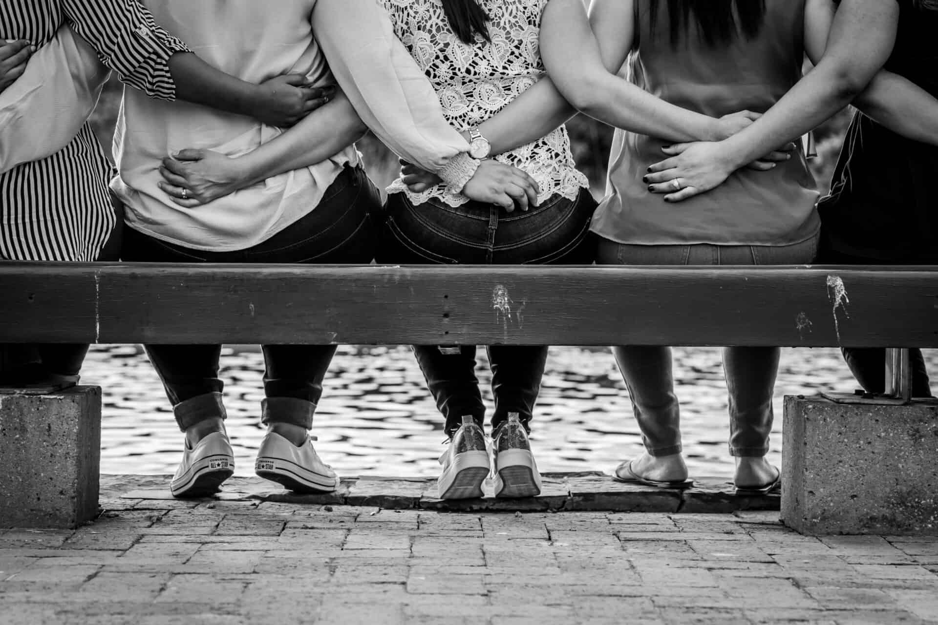 Five women sitting on a bench